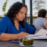 Woman reviewing NDIS pricing schedule document