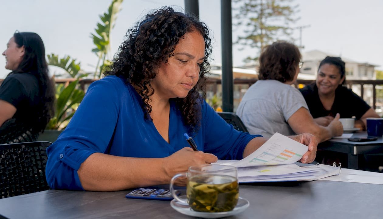 Woman reviewing NDIS pricing schedule document
